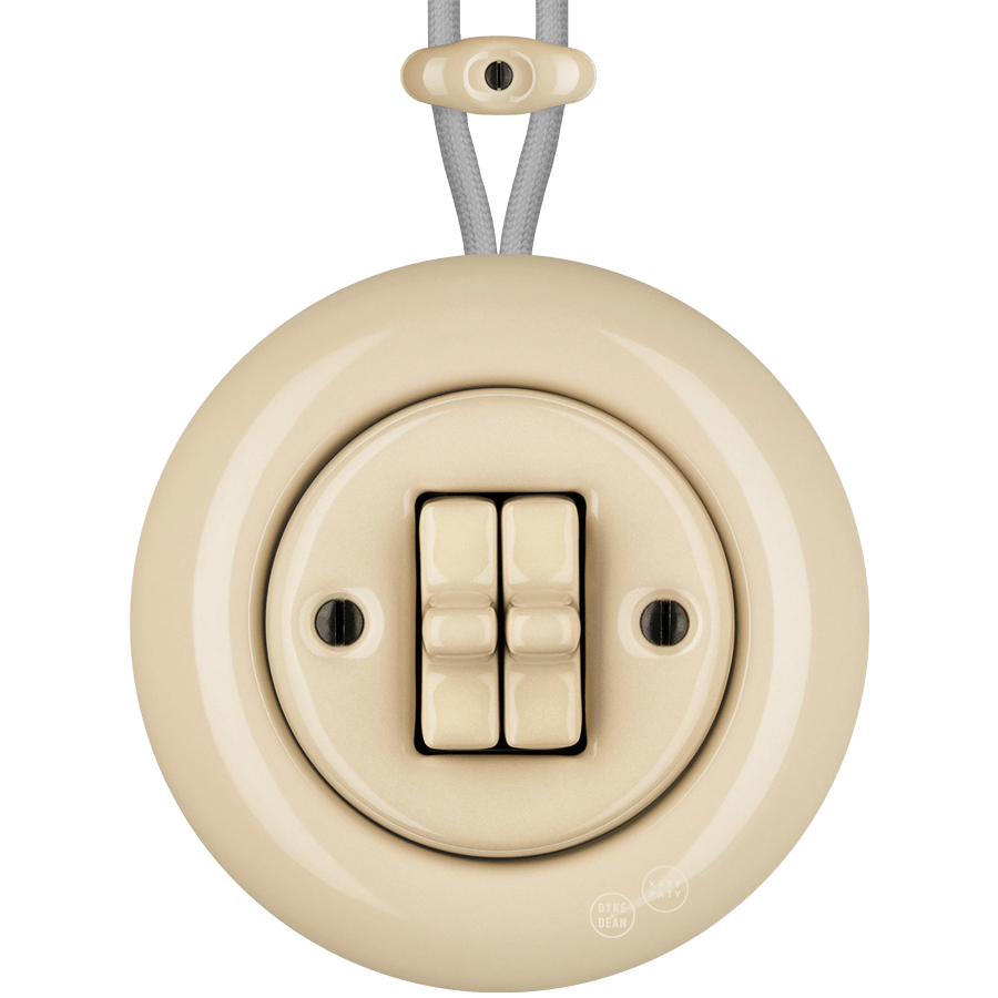 PORCELAIN KATY PATY COLONA ROUND SURFACE MOUNTED DOUBLE TOGGLE BUTTON SWITCH SAND - DYKE & DEAN